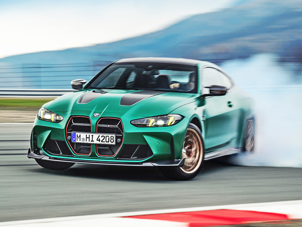 Green 2025 BMW M4 CS sliding on track